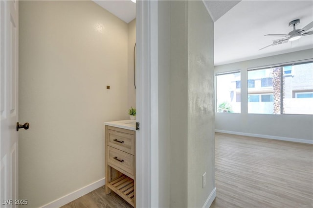 1952 W Hammer Ln, North Las Vegas, NV 89031 - bathroom with wood finished floors, vanity, a ceiling fan, and baseboards