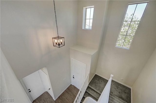 1952 W Hammer Ln, North Las Vegas, NV 89031 - staircase with healthy amount of natural light, baseboards, a chandelier, and a high ceiling