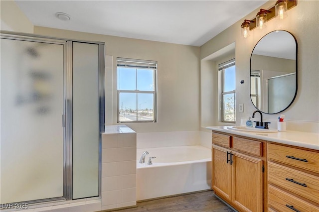 1952 W Hammer Ln, North Las Vegas, NV 89031 - full bath with vanity, a stall shower, a garden tub, and wood finished floors