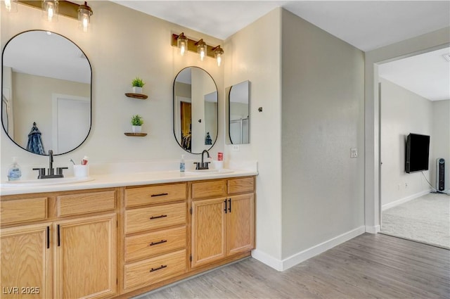 1952 W Hammer Ln, North Las Vegas, NV 89031 - bathroom featuring double vanity, wood finished floors, and baseboards