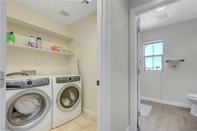 1952 W Hammer Ln, North Las Vegas, NV 89031 - washroom with washing machine and clothes dryer, light wood-type flooring, and baseboards