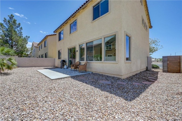 1952 W Hammer Ln, North Las Vegas, NV 89031 - back of house featuring stucco siding, a patio, and a tiled roof