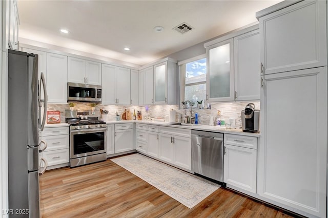 831 E Galingale Ct, Henderson, NV 89015 - kitchen featuring stainless steel appliances, a sink, light countertops, tasteful backsplash, and recessed lighting
