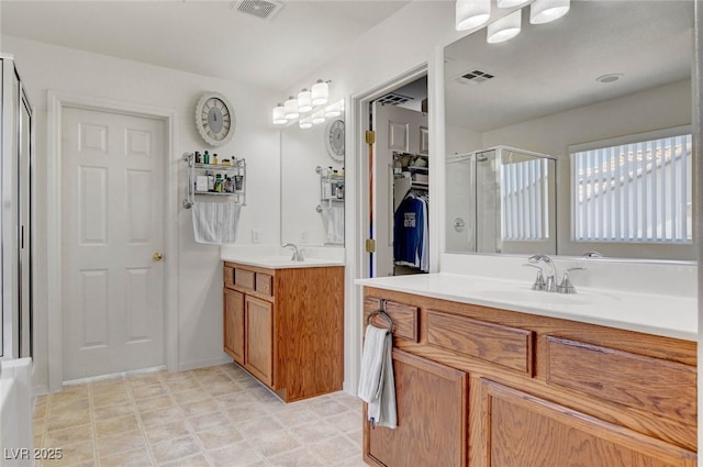 831 E Galingale Ct, Henderson, NV 89015 - bathroom featuring a shower stall and two vanities