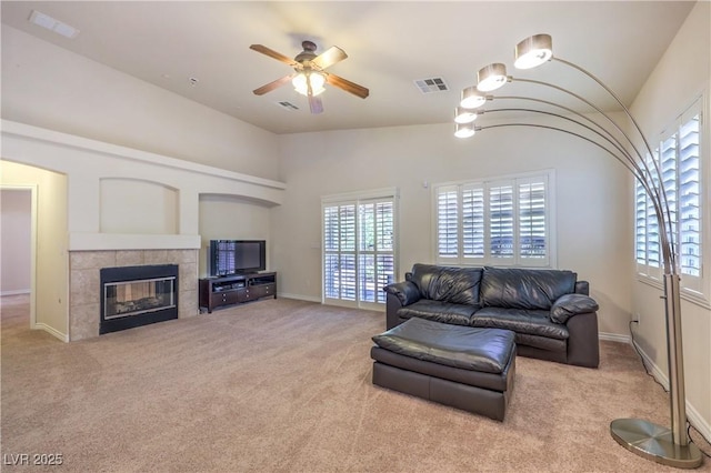 11625 Cabo Del Verde Ave, Las Vegas, NV 89138 - carpeted living room with healthy amount of natural light, vaulted ceiling, a ceiling fan, and a tile fireplace