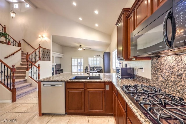 11625 Cabo Del Verde Ave, Las Vegas, NV 89138 - kitchen featuring black appliances, a peninsula, vaulted ceiling, tasteful backsplash, and ceiling fan