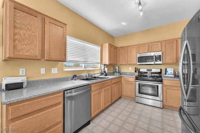 2837 Canonero St, Las Vegas, NV 89142 - kitchen with stainless steel appliances, a sink, light floors, and light brown cabinetry