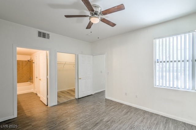 8000 Badura Ave Unit 1168, Las Vegas, NV 89113 - unfurnished bedroom with wood finished floors, baseboards, a closet, a spacious closet, and a ceiling fan