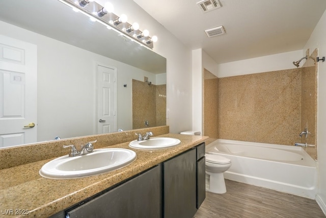 8000 Badura Ave Unit 1168, Las Vegas, NV 89113 - bathroom featuring toilet, double vanity, shower / bath combination, and wood finished floors