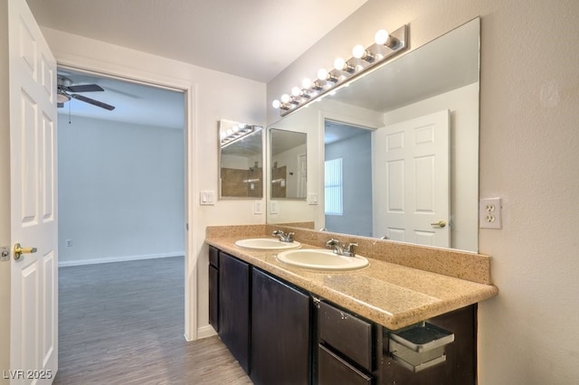 8000 Badura Ave Unit 1168, Las Vegas, NV 89113 - bathroom featuring double vanity, a ceiling fan, wood finished floors, and baseboards
