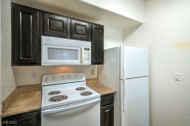 8000 Badura Ave Unit 1168, Las Vegas, NV 89113 - kitchen with white appliances, dark cabinets, and light countertops