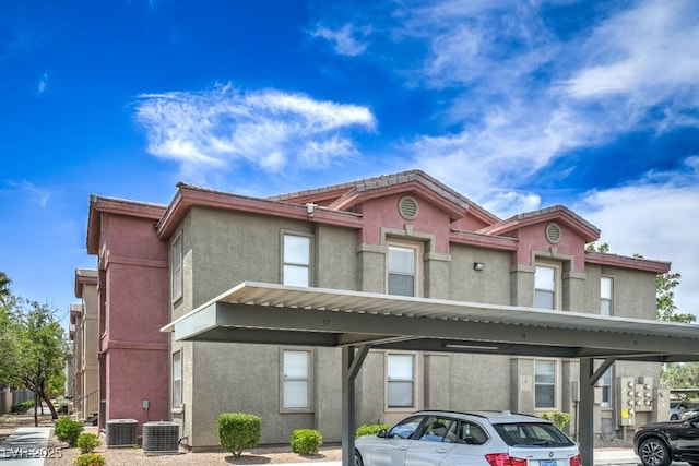 8000 Badura Ave Unit 1168, Las Vegas, NV 89113 - view of front of property with covered parking, stucco siding, and central AC unit