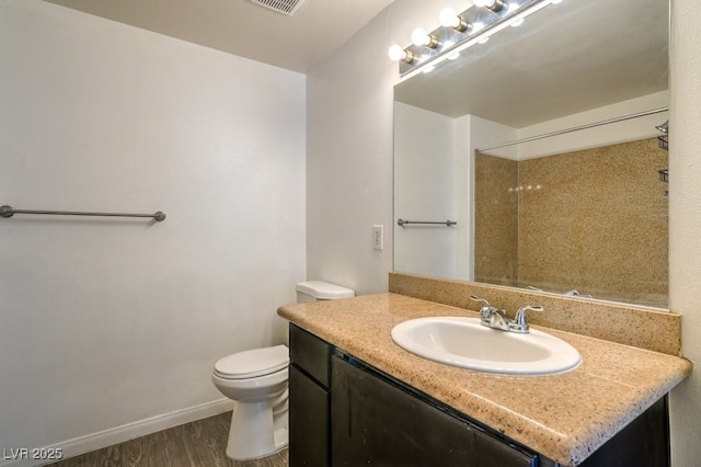 8000 Badura Ave Unit 1168, Las Vegas, NV 89113 - full bathroom with vanity, toilet, wood finished floors, baseboards, and a shower