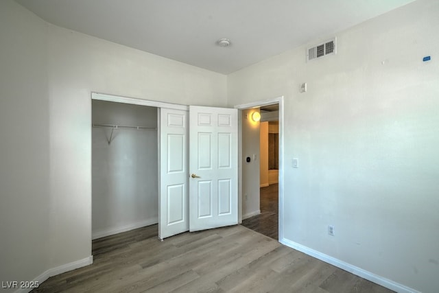 8000 Badura Ave Unit 1168, Las Vegas, NV 89113 - unfurnished bedroom featuring baseboards, wood finished floors, and a closet