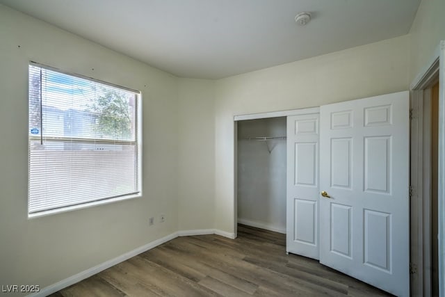 8000 Badura Ave Unit 1168, Las Vegas, NV 89113 - unfurnished bedroom featuring wood finished floors, a closet, and baseboards
