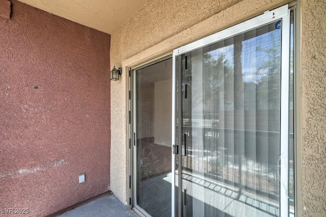 8000 Badura Ave Unit 1168, Las Vegas, NV 89113 - property entrance featuring a balcony and stucco siding