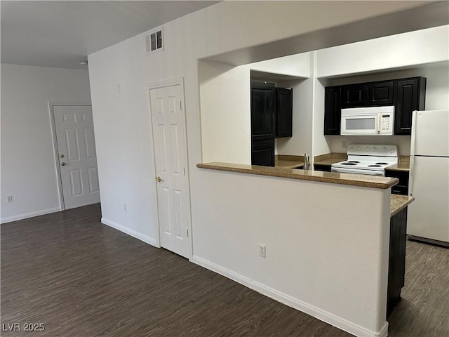8000 Badura Ave Unit 1168, Las Vegas, NV 89113 - kitchen with white appliances, dark cabinets, dark wood finished floors, and a peninsula