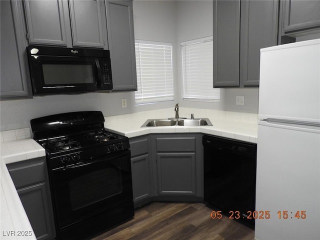 75 N Valle Verde Dr Unit 411, Henderson, NV 89074 - kitchen featuring black appliances, a sink, tile countertops, gray cabinets, and dark wood finished floors