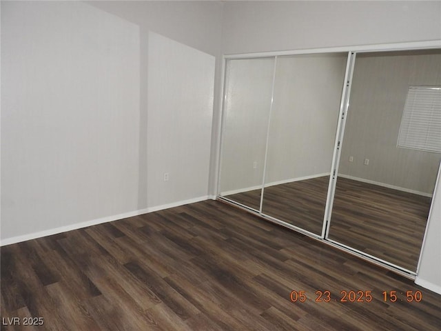 75 N Valle Verde Dr Unit 411, Henderson, NV 89074 - unfurnished bedroom featuring wood finished floors, a closet, and baseboards