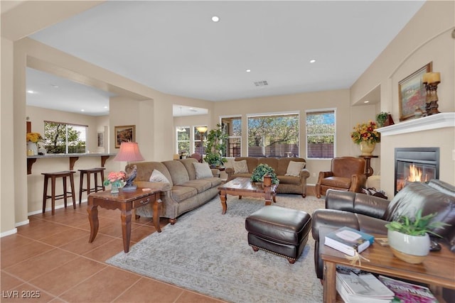 9375 Gold Lake Ave, Las Vegas, NV 89149 - tiled living room featuring a glass covered fireplace, recessed lighting, and baseboards