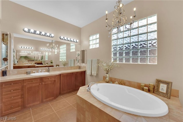 9375 Gold Lake Ave, Las Vegas, NV 89149 - bathroom with a chandelier, a garden tub, vanity, and tile patterned floors