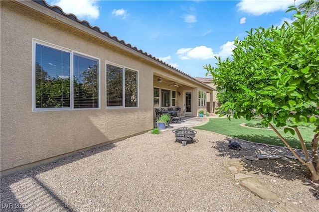 9375 Gold Lake Ave, Las Vegas, NV 89149 - back of house featuring an outdoor fire pit, a patio area, stucco siding, ceiling fan, and a tile roof