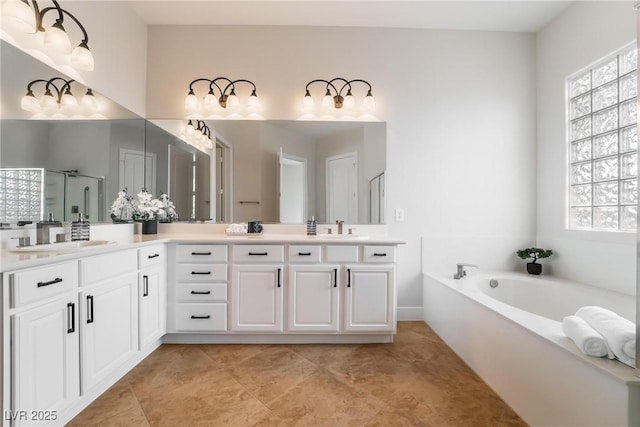 2365 Black River Falls Dr, Henderson, NV 89044 - full bath with healthy amount of natural light, double vanity, a shower stall, and a garden tub