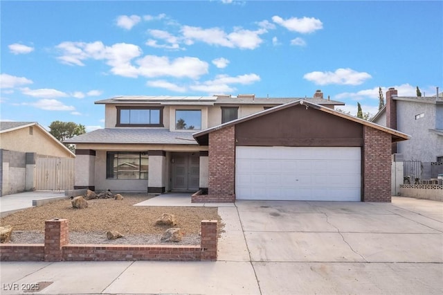 7009 Rawlins Ct, Las Vegas, NV 89128 - view of front of home featuring solar panels, concrete driveway, an attached garage, and stucco siding