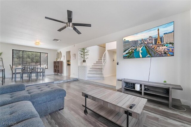 7009 Rawlins Ct, Las Vegas, NV 89128 - living area with stairs, wood finished floors, a ceiling fan, and baseboards
