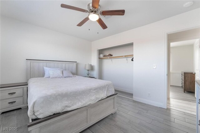 7009 Rawlins Ct, Las Vegas, NV 89128 - bedroom with baseboards, light wood-style flooring, a closet, and a ceiling fan