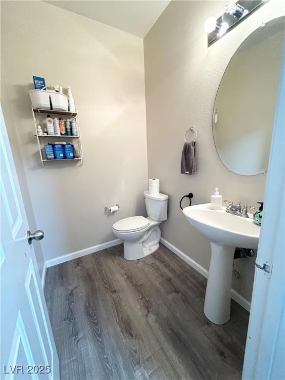 6812 Dipper Ave, North Las Vegas, NV 89084 - half bath with wood finished floors, toilet, and baseboards