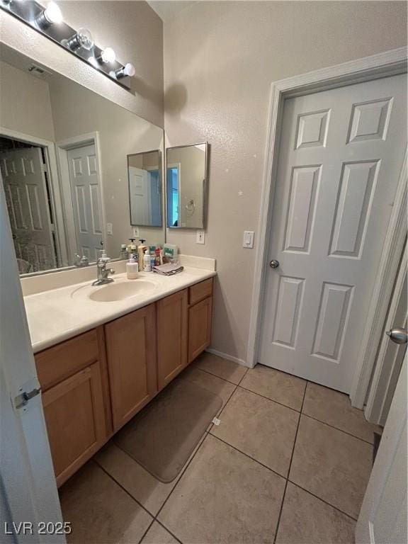 6812 Dipper Ave, North Las Vegas, NV 89084 - bathroom with tile patterned flooring and vanity