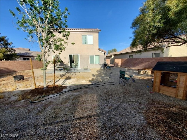 6812 Dipper Ave, North Las Vegas, NV 89084 - back of property with stucco siding, a patio, a fenced backyard, and a tile roof
