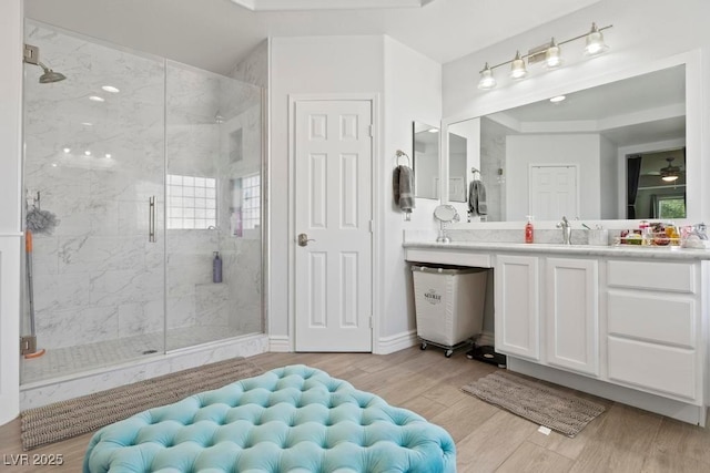 8121 Eagle Clan Ct, Las Vegas, NV 89131 - bathroom featuring a stall shower, wood finished floors, vanity, and ceiling fan
