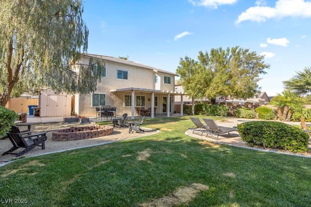 8121 Eagle Clan Ct, Las Vegas, NV 89131 - back of house featuring an outdoor fire pit, a patio area, a yard, and stucco siding