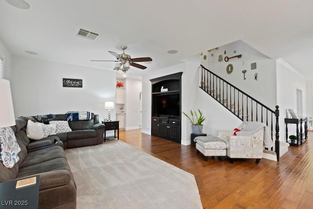 8121 Eagle Clan Ct, Las Vegas, NV 89131 - living area featuring a ceiling fan, stairs, wood finished floors, and baseboards