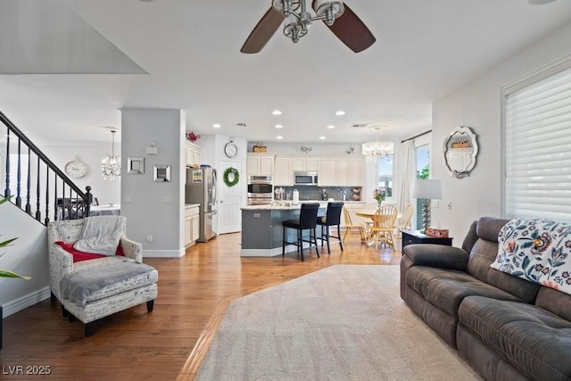 8121 Eagle Clan Ct, Las Vegas, NV 89131 - living area with a chandelier, a ceiling fan, light wood-style flooring, recessed lighting, and baseboards