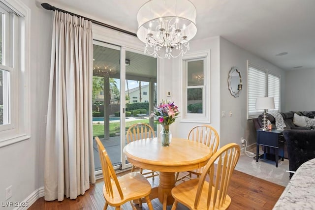 8121 Eagle Clan Ct, Las Vegas, NV 89131 - dining space featuring a chandelier, baseboards, wood finished floors, and a baseboard radiator