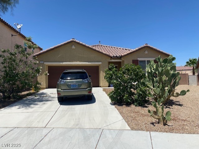 152 Lotus Vale Ave, Las Vegas, NV 89123 - view of front of home with stucco siding, driveway, a tile roof, and a garage