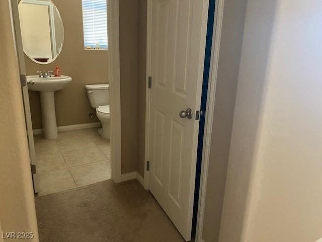 152 Lotus Vale Ave, Las Vegas, NV 89123 - bathroom featuring toilet, baseboards, tile patterned flooring, and a sink