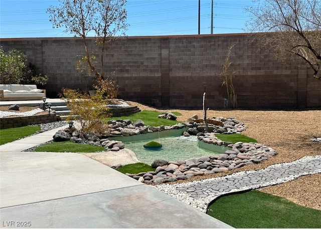 2429 Worchester Rd, Henderson, NV 89074 - fenced backyard featuring a small pond
