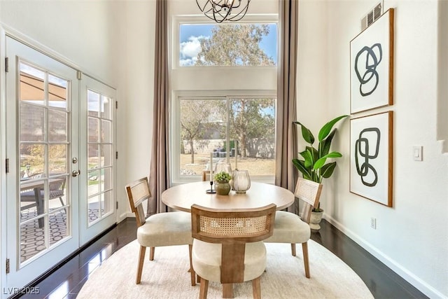 2429 Worchester Rd, Henderson, NV 89074 - dining room featuring french doors, baseboards, a high ceiling, a chandelier, and wood finished floors
