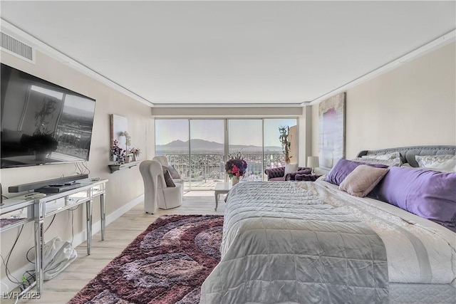 3111 Bel Air Dr Unit 22B, Las Vegas, NV 89109 - bedroom featuring ornamental molding, light wood finished floors, and access to exterior