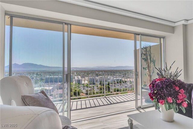 3111 Bel Air Dr Unit 22B, Las Vegas, NV 89109 - bedroom with access to outside, wood finished floors, and a mountain view