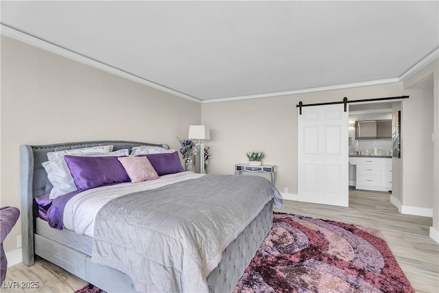 3111 Bel Air Dr Unit 22B, Las Vegas, NV 89109 - bedroom featuring crown molding, light wood finished floors, and a barn door