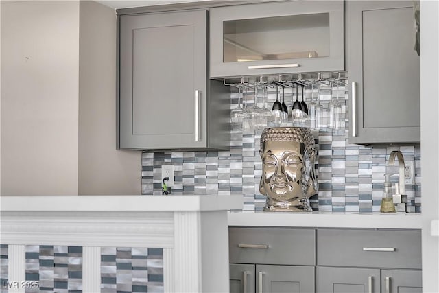 3111 Bel Air Dr Unit 22B, Las Vegas, NV 89109 - kitchen with gray cabinetry, backsplash, and light countertops