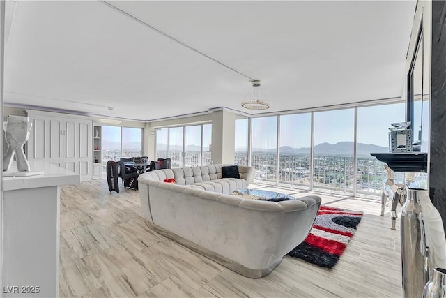 3111 Bel Air Dr Unit 22B, Las Vegas, NV 89109 - living room featuring a mountain view, plenty of natural light, and expansive windows
