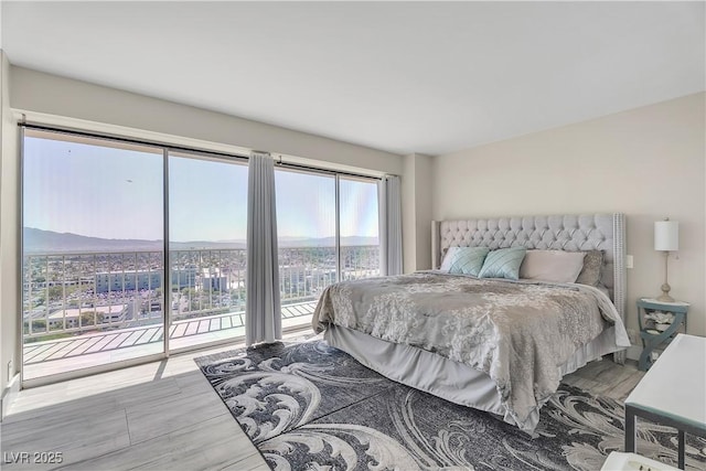 3111 Bel Air Dr Unit 22B, Las Vegas, NV 89109 - bedroom featuring access to exterior and wood finished floors