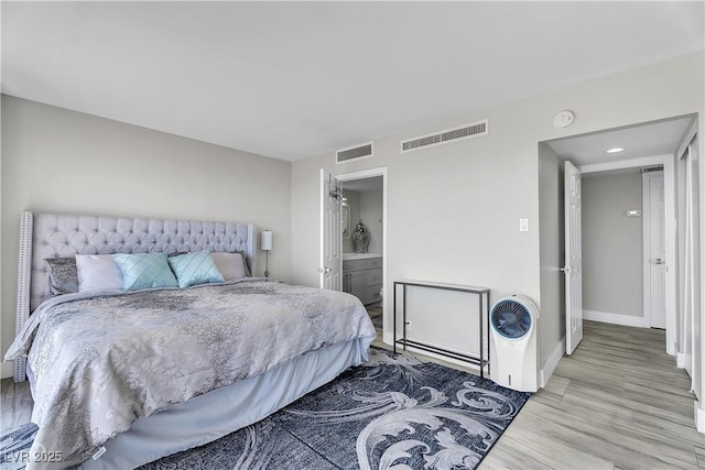 3111 Bel Air Dr Unit 22B, Las Vegas, NV 89109 - bedroom with light wood finished floors, ensuite bathroom, and recessed lighting