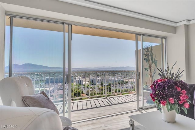 3111 Bel Air Dr Unit 22B, Las Vegas, NV 89109 - bedroom with access to outside, wood finished floors, and a mountain view